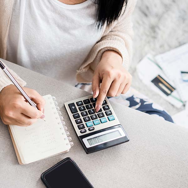 Woman using a blue and black calculator