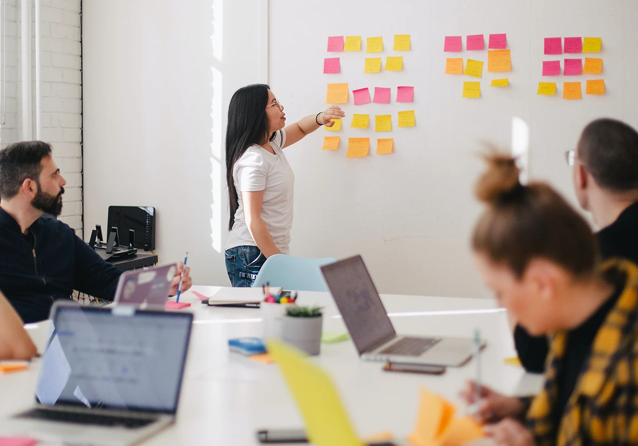 office workers around a whiteboard