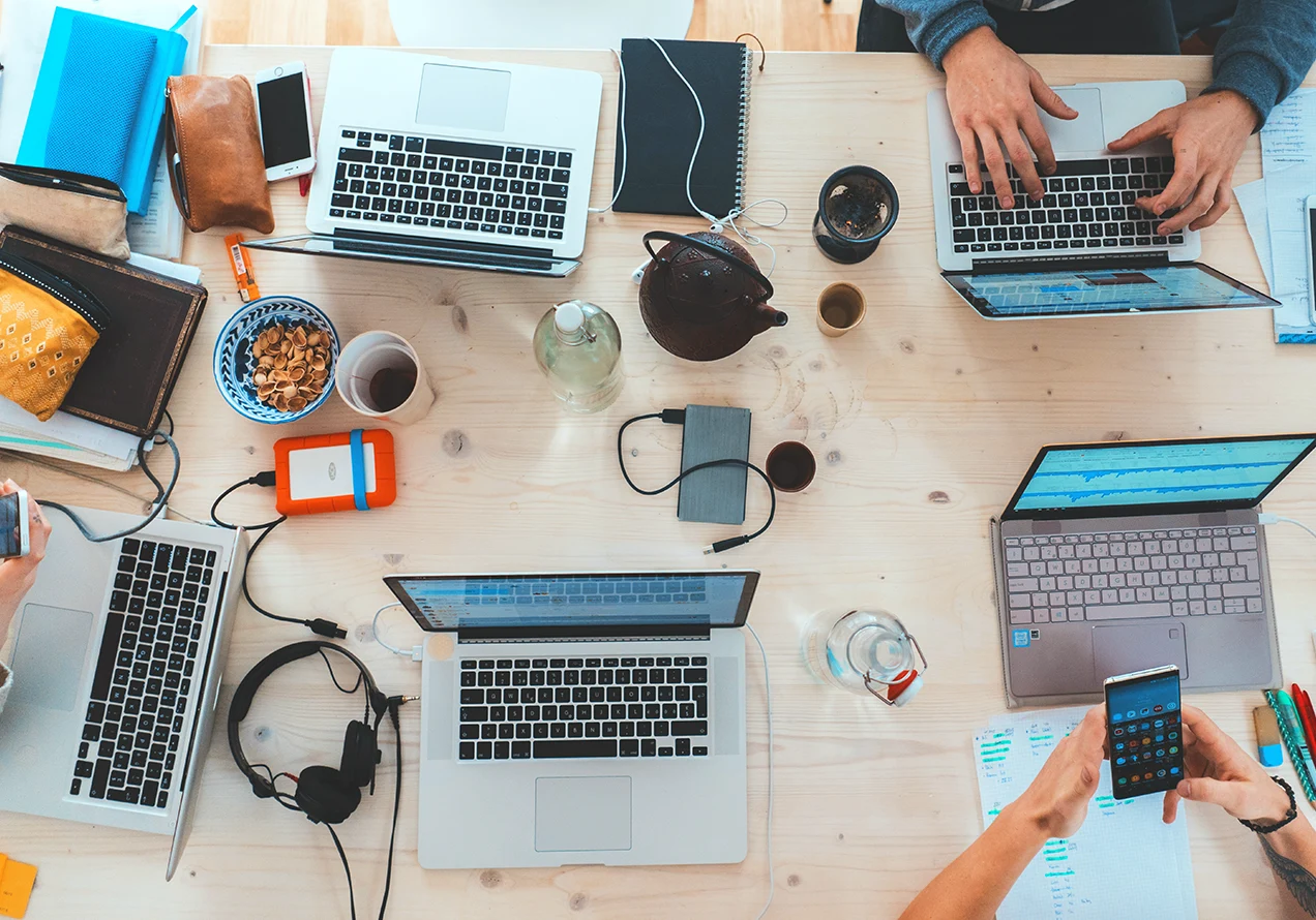 many people working on content around a table