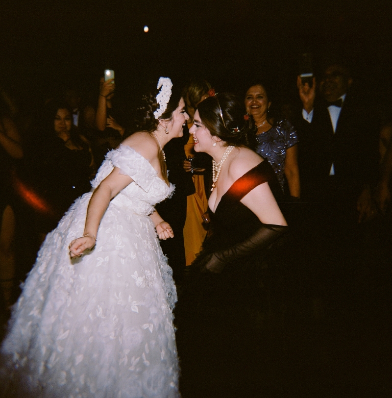 a bride dancing with her bridesmaid