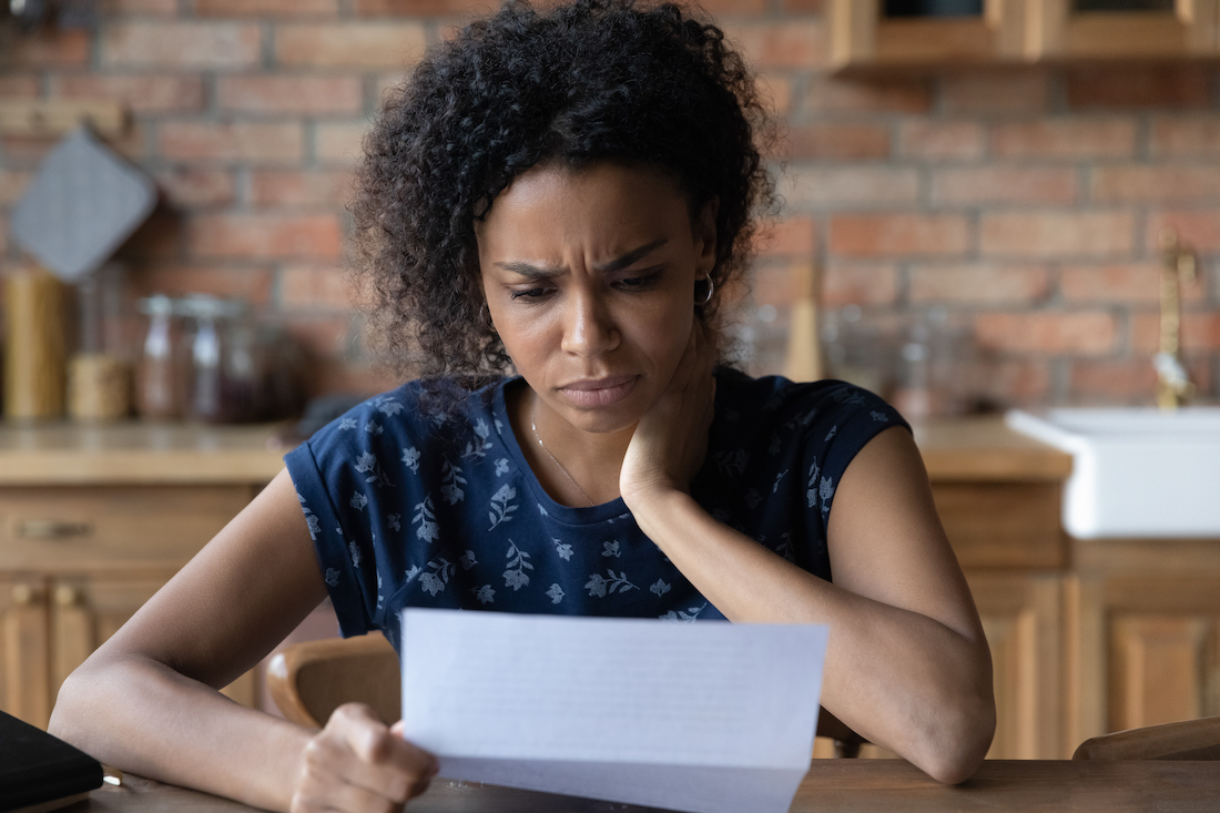 Black woman looking at a bill.jpg